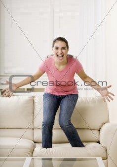 Young Woman Standing on Couch