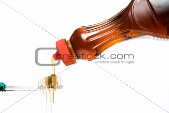 Maple Syrup Pouring Over a Tooth Brush