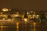 prague, charles bridge - boat traffic on vltava river at night