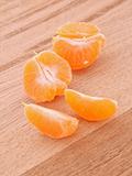 tangerine segments on wooden background