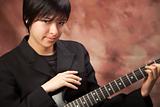 Multiethnic Girl Poses with Her Electric Guitar.