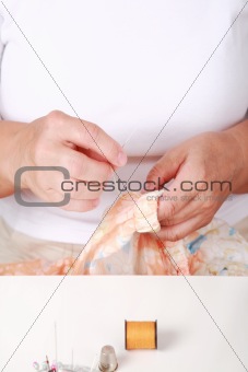 Elderly woman sewing