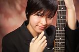 Multiethnic Girl Poses with Her Electric Guitar.