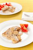 hake fillets with cheese sauce and mushrooms isolated