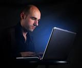 Businessman working at computer laptop in night