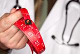 Doctor with Stethoscope Holding Red Measuring Tape.