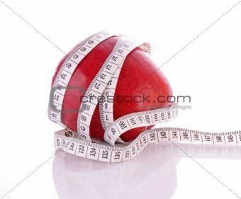 White tape measure around a red apple representing dieting