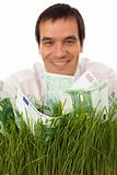 Businessman with green banknotes in grass