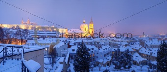 prague - panorama of hradcany castle and st. nicolaus church in winter