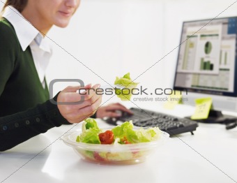 businesswoman eating salad