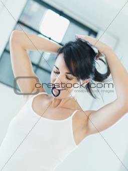 woman tieing hair