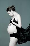 expecting woman - studio shot of a pregnant woman with cloth