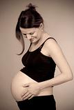 expecting woman - studio shot of a pregnant woman smiling