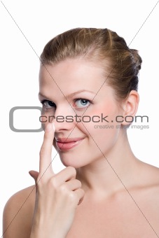 women applying cream to her nose