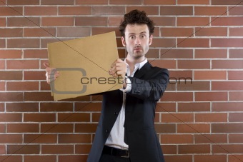 poor unshaved businessman pleads with a blank sign