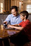 Man and Young Boy on Laptop