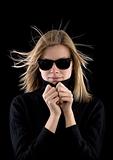 blonde girl in a black turtleneck with retro sunglasses