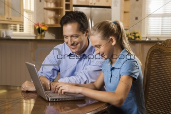 Man and Girl Working on Laptop