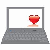 Notebook computer with red heart on a desktop