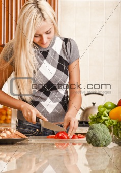 Young Woman Cutting Tomato