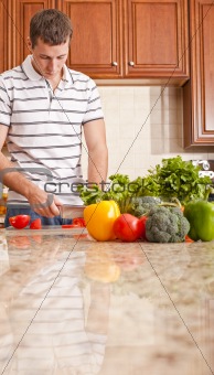 Young Man Cutting Tomato