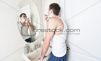 Young Man in Bathroom Shaving