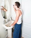 Young Man in Bathroom Shaving