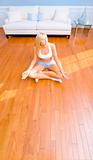 Young Woman Sitting on Wood Floor Meditating