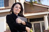 Proud, Attractive Hispanic Real Estate Agent Woman in Front of New Home.