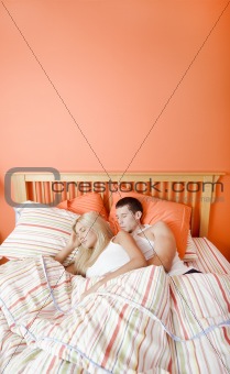 Young Couple Sleeping in Bed