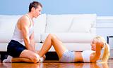 Couple Exercising on Living Room Floor
