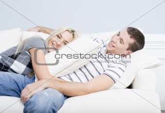 Young Couple Reclining on Sofa
