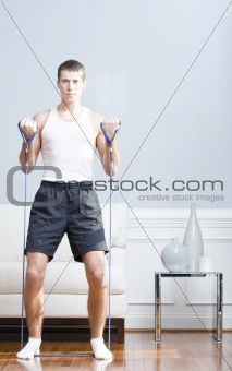 Man Using Resistance Bands in Living Room
