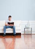 Man Reading on Living Room Couch