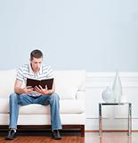 Man Reading on Living Room Couch