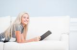 Smiling Woman Reclining on Couch With Book