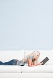 Woman Reclining on Couch With Book