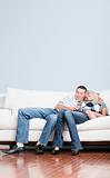 Affectionate Couple Laughing and Relaxing on Couch