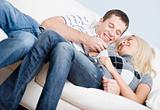 Affectionate Couple Laughing and Relaxing on Couch