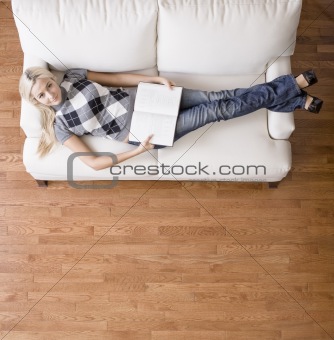 Overhead View of Woman With Book on Couch