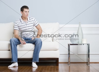 Man Sitting on Living Room Couch