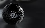 Black, glossy golf ball with alpha channel.