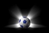 Glowing soccer ball over black background with alpha channel