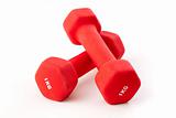 Two red dumbbells on white background