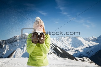 woman blowing on snow