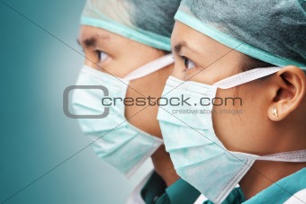 Two Asian surgeon looking away