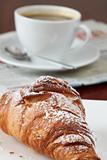 Croissant, coffee and newspaper