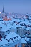 prague - winter view of mala strana rooftops covered with snow 