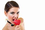 attractive woman biting a red heart