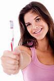 beautiful young woman holding toothbrush and smiling